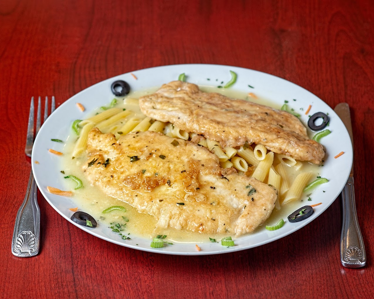 Breaded chicken over penne pasta at Vincenzo's Pizza