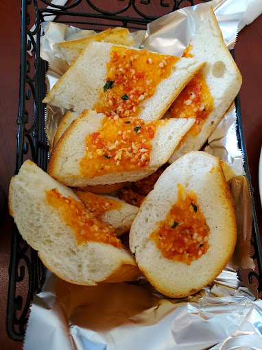 Garlic bread with tomato and herbs at Vincenzo's Pizza