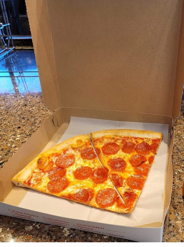 Pepperoni pizza slices in a takeout box from Vincenzo's Pizza